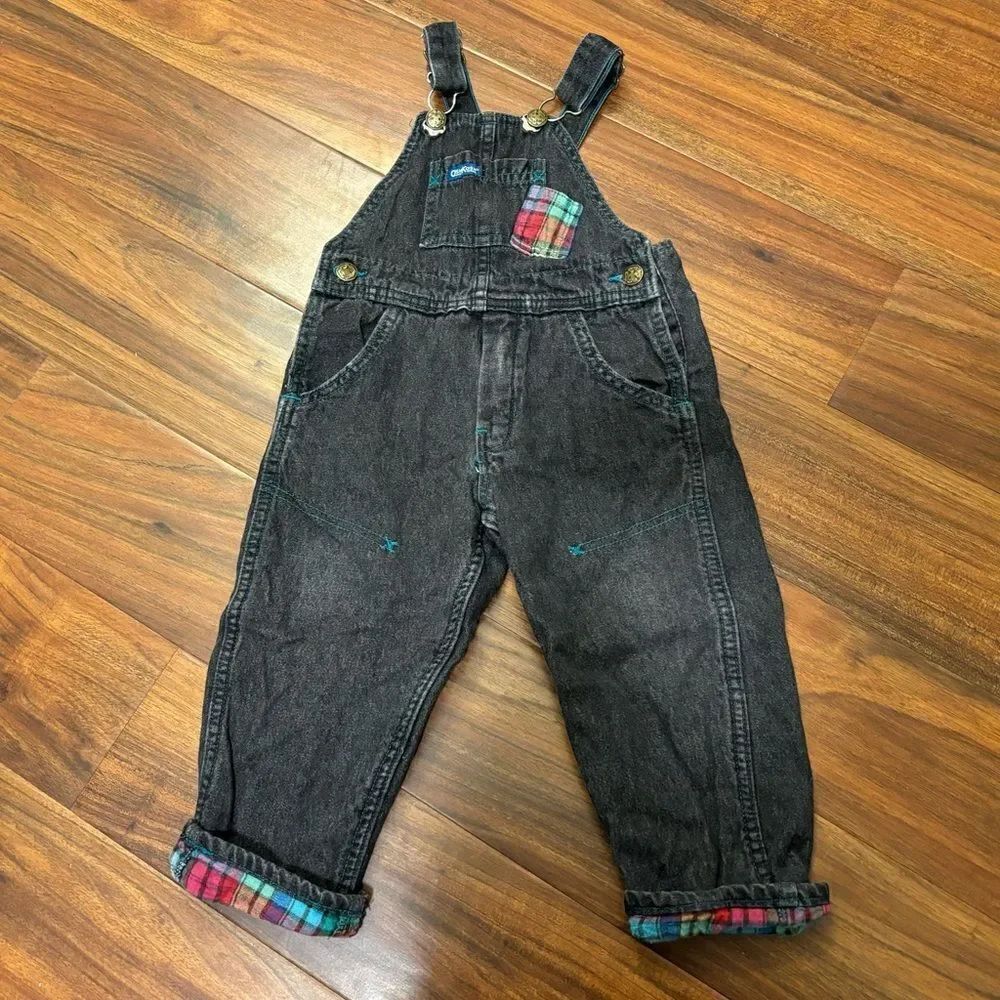 Osh Kosh B’Gosh Vintage black denim overalls with plaid accents.